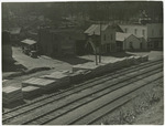 Stacked railroad ties awaiting shipment along a railroad track